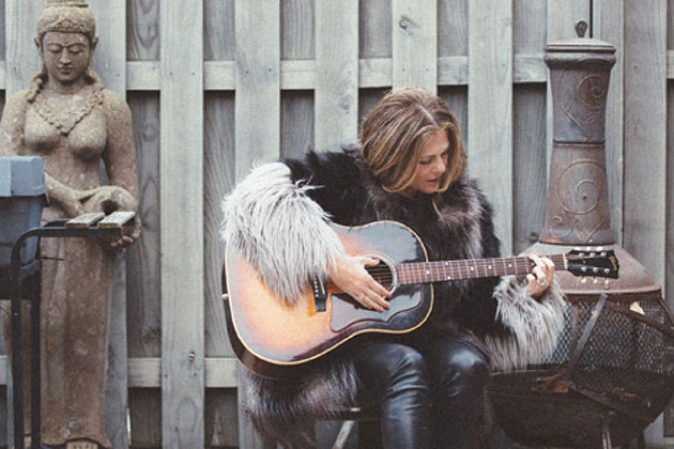 Rita Wilson playing the guitar