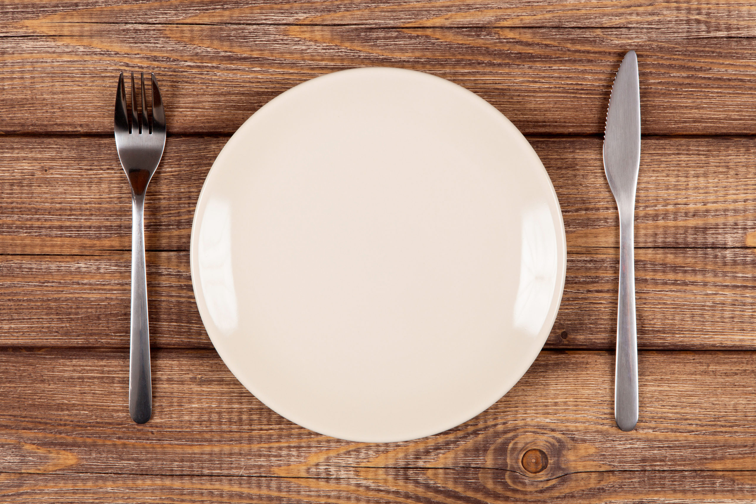 Empty plate on a wooden table