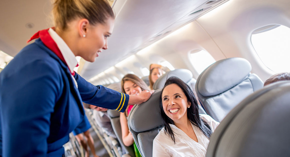 A passenger and a flight attendant talking